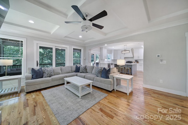 463 Lake Wylie Rd, Belmont, NC 28012 - living room with arched walkways, ceiling fan, light wood-style floors, recessed lighting, and a tray ceiling