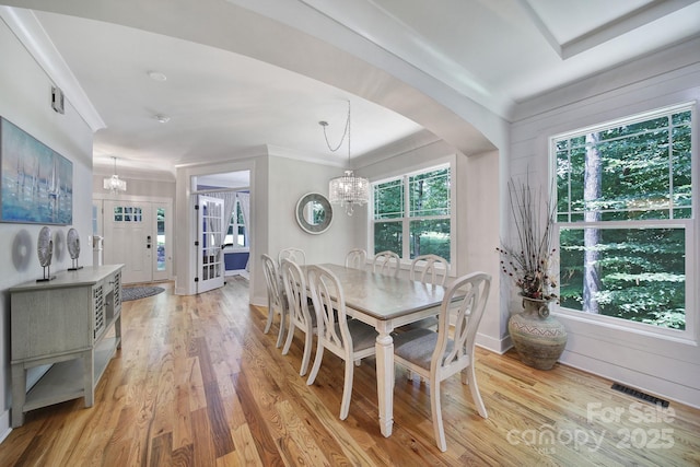 463 Lake Wylie Rd, Belmont, NC 28012 - dining area with a chandelier, light wood-style flooring, arched walkways, crown molding, and french doors