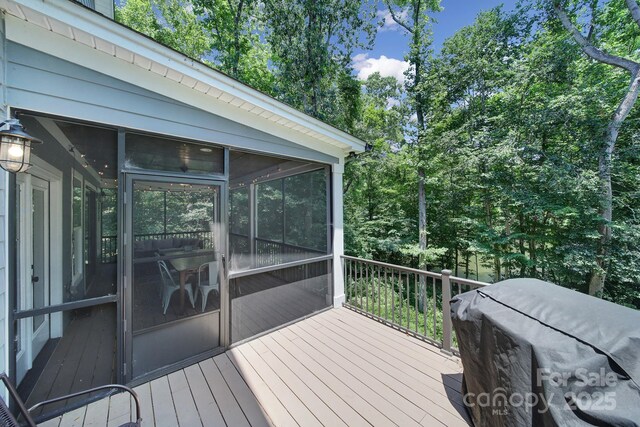463 Lake Wylie Rd, Belmont, NC 28012 - deck featuring a sunroom, a grill, and view of wooded area