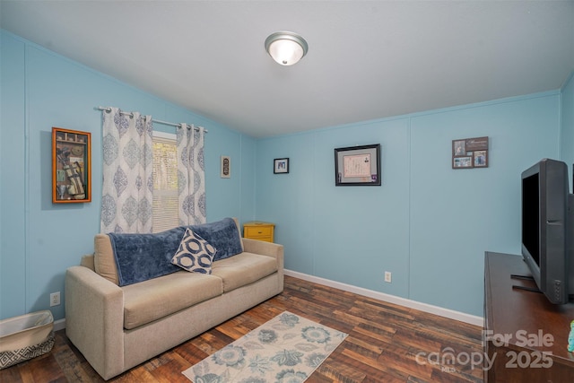 living room featuring lofted ceiling, wood finished floors, and baseboards