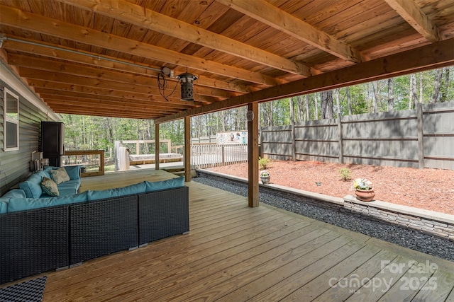 wooden terrace featuring fence and an outdoor living space