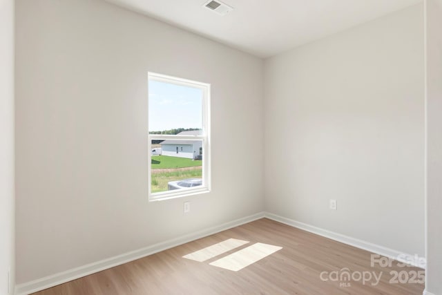 unfurnished room with visible vents, baseboards, and light wood finished floors