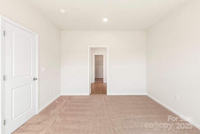 spare room featuring recessed lighting, baseboards, and carpet floors