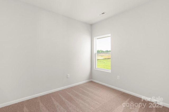 unfurnished room featuring visible vents, baseboards, and light colored carpet