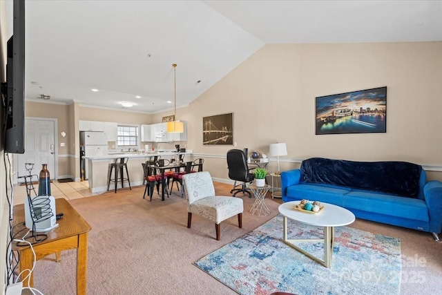 living area featuring baseboards, lofted ceiling, light tile patterned floors, and light colored carpet