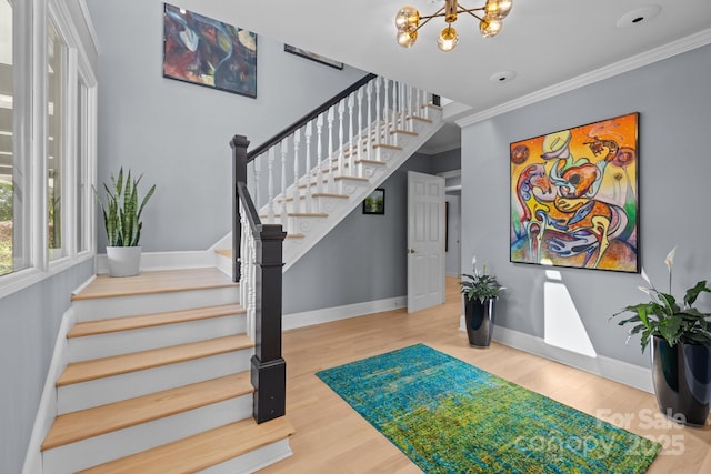 15921 Cramur Dr, Huntersville, NC 28078 - staircase featuring baseboards, ornamental molding, wood finished floors, and a notable chandelier