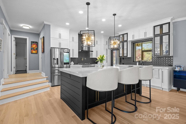 15921 Cramur Dr, Huntersville, NC 28078 - kitchen with white cabinetry, light wood-style flooring, stainless steel fridge with ice dispenser, and crown molding