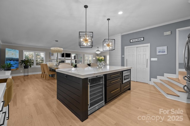 15921 Cramur Dr, Huntersville, NC 28078 - kitchen with crown molding, stainless steel microwave, decorative light fixtures, light wood-style floors, and beverage cooler