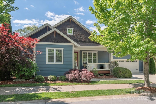 4 Silo View Ct, Asheville, NC 28804 - craftsman house with covered porch, stone siding, concrete driveway, and an attached garage