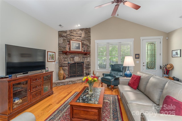 4 Silo View Ct, Asheville, NC 28804 - living area featuring wood finished floors, vaulted ceiling, a ceiling fan, and a fireplace