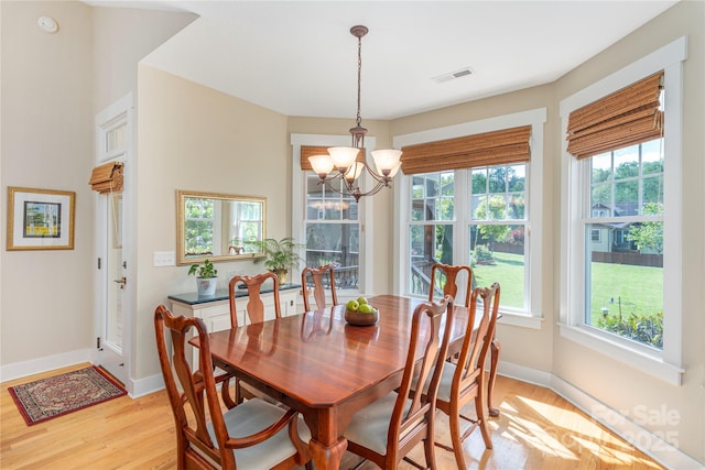 4 Silo View Ct, Asheville, NC 28804 - dining space featuring light wood-type flooring, a chandelier, healthy amount of natural light, and baseboards