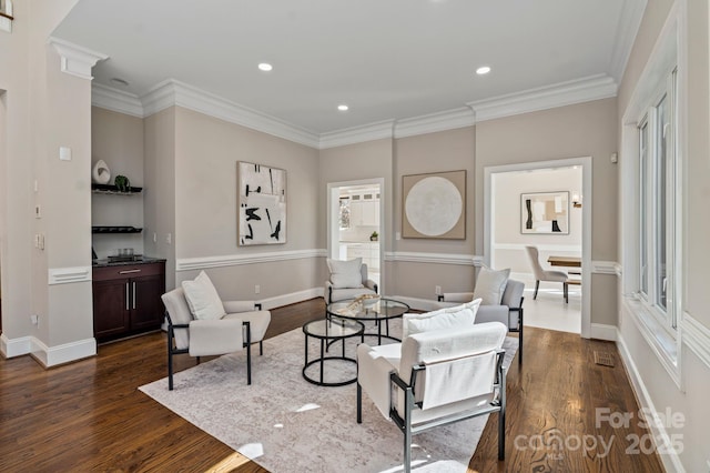 living room with crown molding, recessed lighting, and dark wood-style flooring