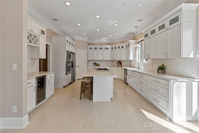 kitchen featuring crown molding, stainless steel appliances, wine cooler, decorative backsplash, and a sink