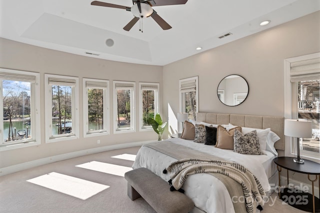 bedroom featuring recessed lighting, carpet, baseboards, a raised ceiling, and visible vents