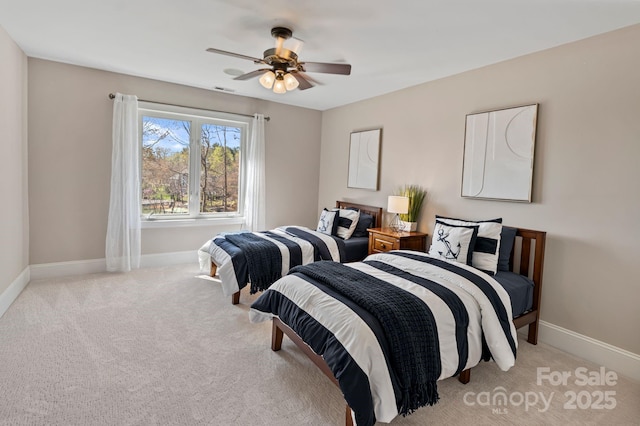 bedroom featuring baseboards, visible vents, a ceiling fan, and light colored carpet