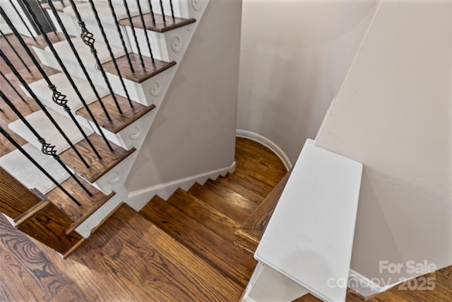stairs with baseboards and wood finished floors