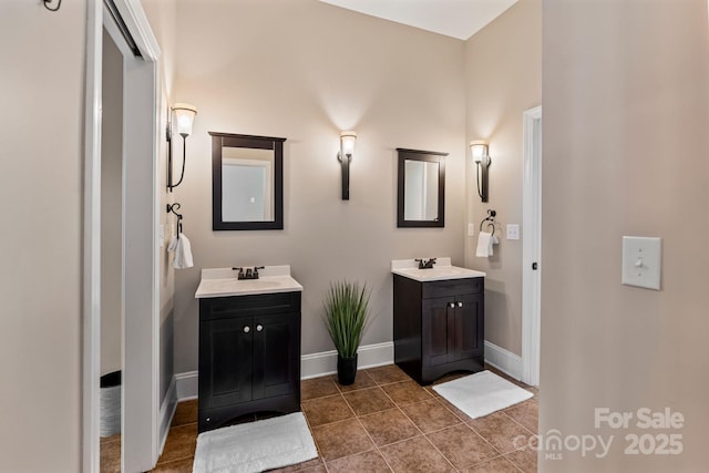 full bath featuring tile patterned flooring, a sink, and two vanities