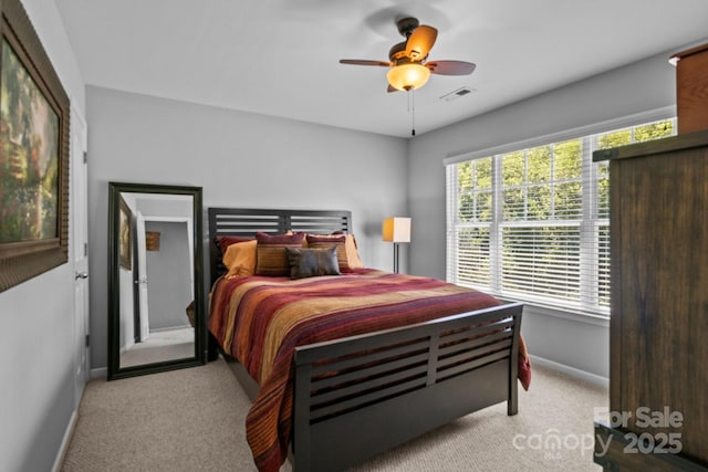 bedroom featuring ceiling fan, carpet floors, visible vents, and baseboards