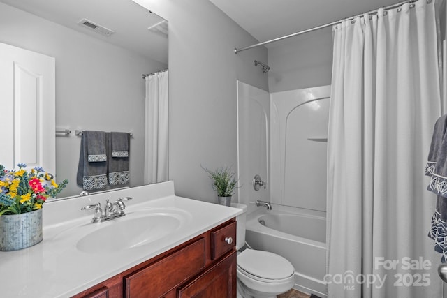 full bath with visible vents, toilet, vanity, and shower / tub combo