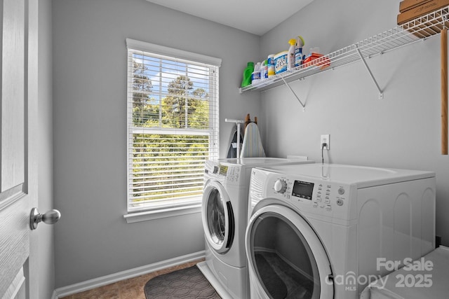 washroom with separate washer and dryer, laundry area, and plenty of natural light