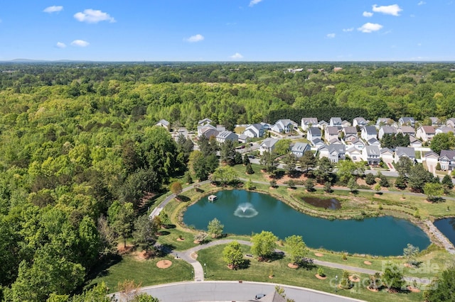 bird's eye view featuring a view of trees and a water view