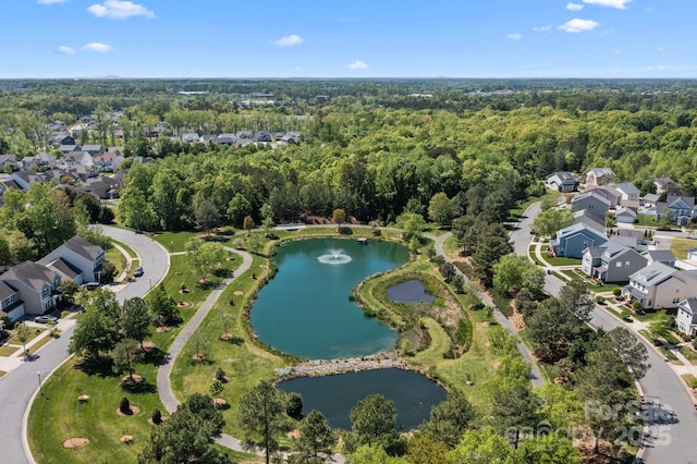 birds eye view of property featuring a view of trees, a residential view, and a water view