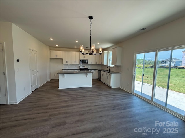 317 Maidstone Dr Unit 57, Monroe, NC 28110 - kitchen with appliances with stainless steel finishes, a chandelier, dark countertops, white cabinetry, and recessed lighting