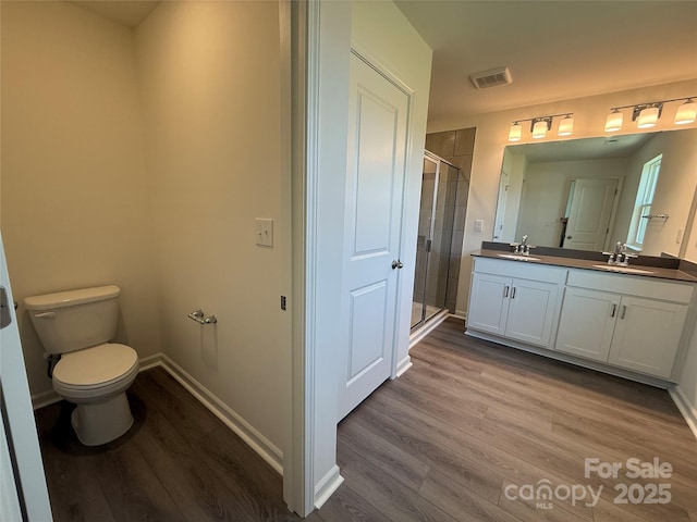 317 Maidstone Dr Unit 57, Monroe, NC 28110 - bathroom with wood finished floors, double vanity, and a stall shower