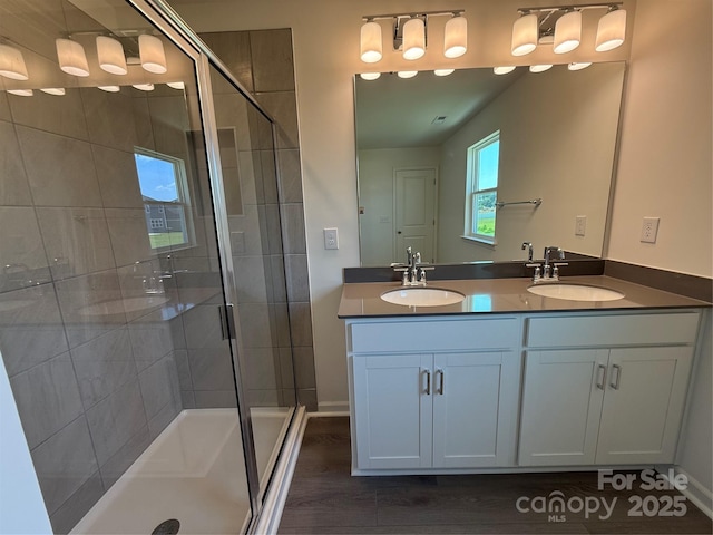 317 Maidstone Dr Unit 57, Monroe, NC 28110 - bathroom featuring double vanity, a shower stall, and wood finished floors