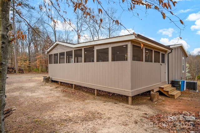 view of property exterior with a sunroom