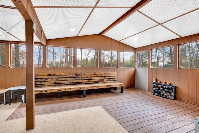 sunroom / solarium with a healthy amount of sunlight and beamed ceiling