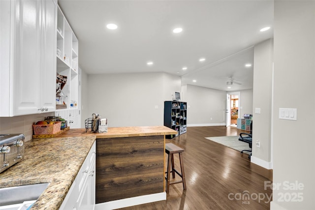 kitchen featuring white cabinetry, dark wood-type flooring, and recessed lighting