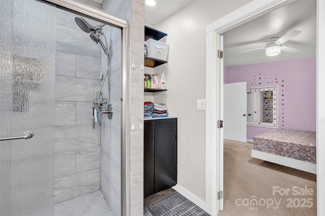bathroom featuring baseboards, tiled shower, and ceiling fan