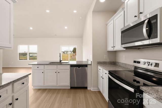 3327 Burberry Dr, Gastonia, NC 28052 - kitchen with a peninsula, recessed lighting, a sink, white cabinets, and appliances with stainless steel finishes