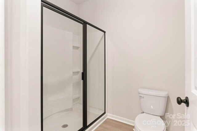 3327 Burberry Dr, Gastonia, NC 28052 - full bath with a shower stall, toilet, wood finished floors, and baseboards
