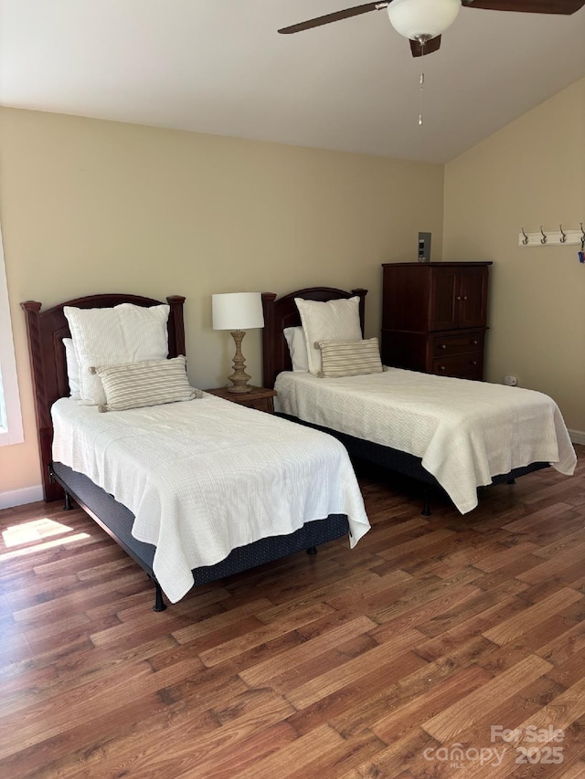 bedroom featuring wood finished floors, ceiling fan, and lofted ceiling