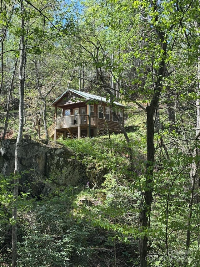 view of outbuilding featuring a forest view