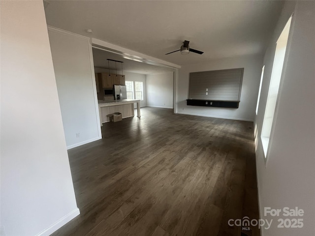 2070 Travis Rd, Conover, NC 28613 - unfurnished living room with ceiling fan, baseboards, and dark wood finished floors