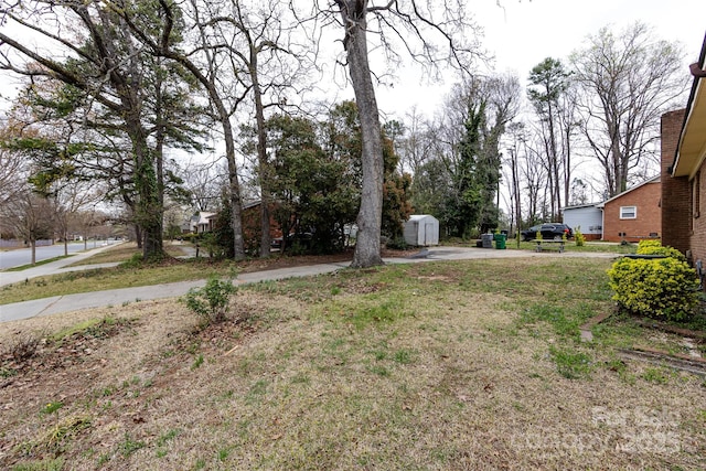 view of yard featuring an outbuilding and a storage shed