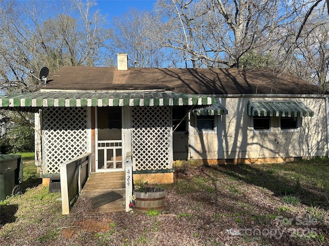 back of property featuring a chimney