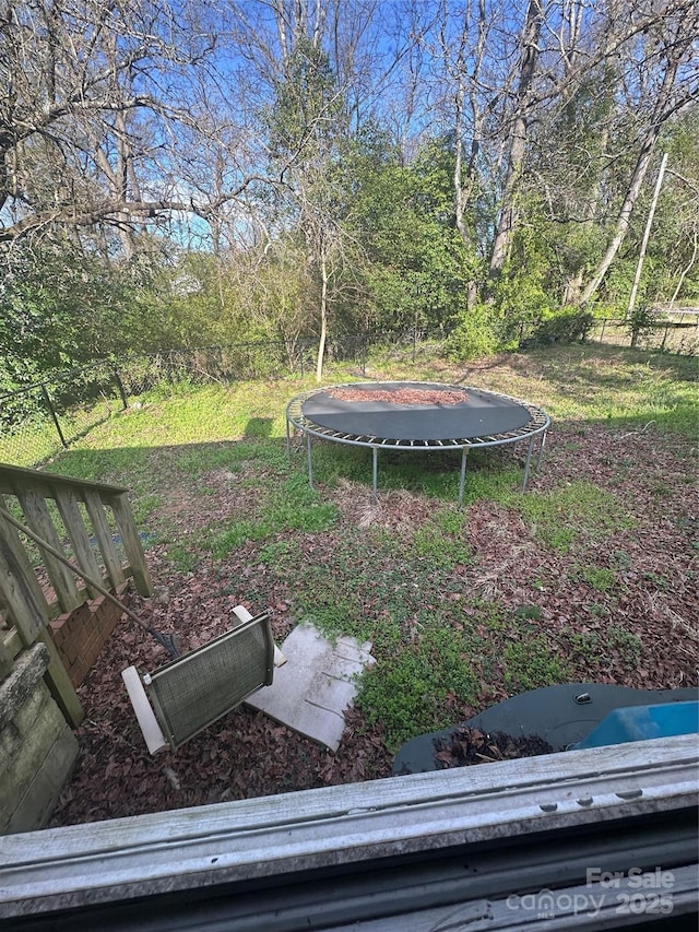 view of yard with a trampoline