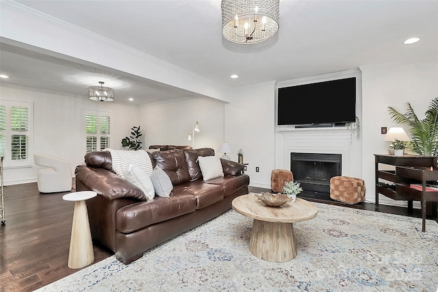 living room with crown molding, recessed lighting, a chandelier, and dark wood-type flooring