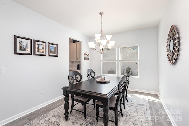 1512 Brooksland Pl, Waxhaw, NC 28173 - dining space with wood finished floors, a chandelier, and baseboards
