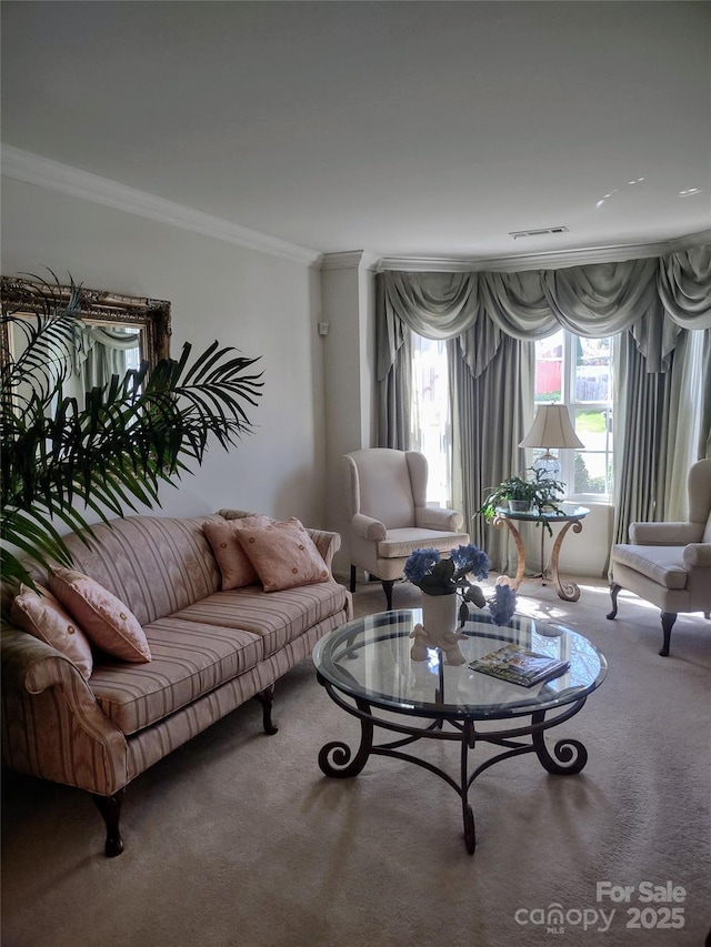 living room with carpet floors, ornamental molding, and visible vents