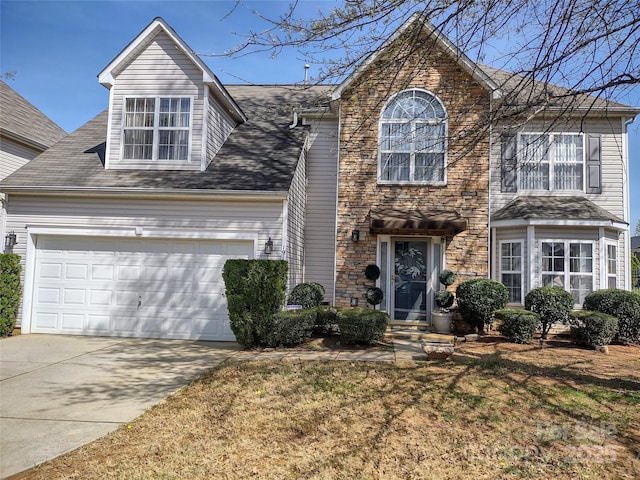 view of front of property featuring driveway and an attached garage
