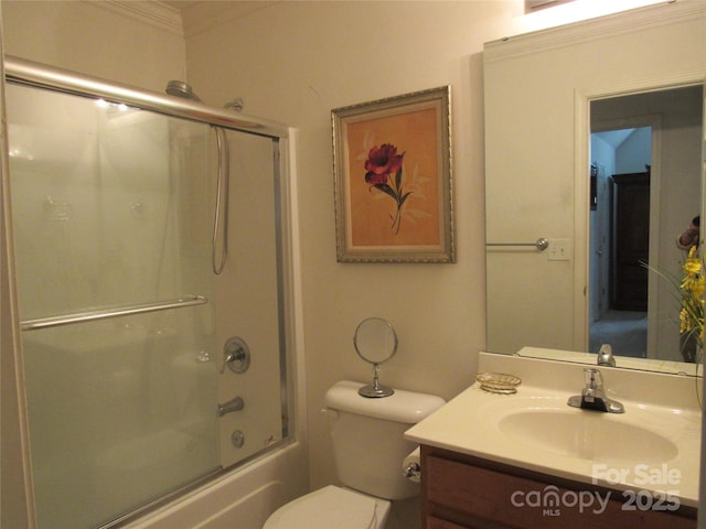 bathroom with toilet, vanity, and bath / shower combo with glass door