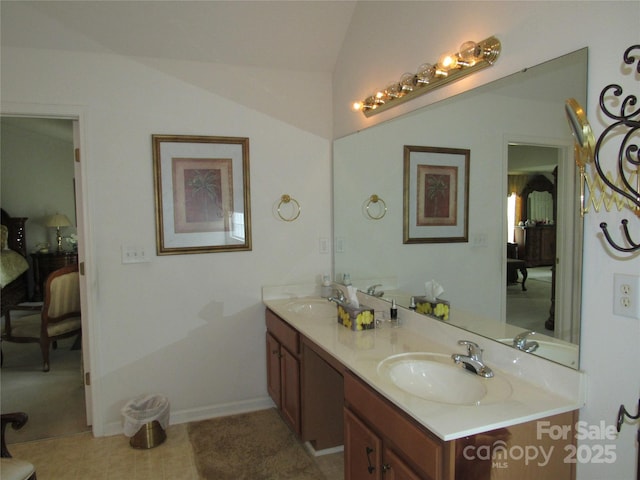 bathroom featuring double vanity, a sink, and ensuite bath