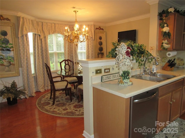 kitchen with light countertops, an inviting chandelier, stainless steel dishwasher, a sink, and wood finished floors