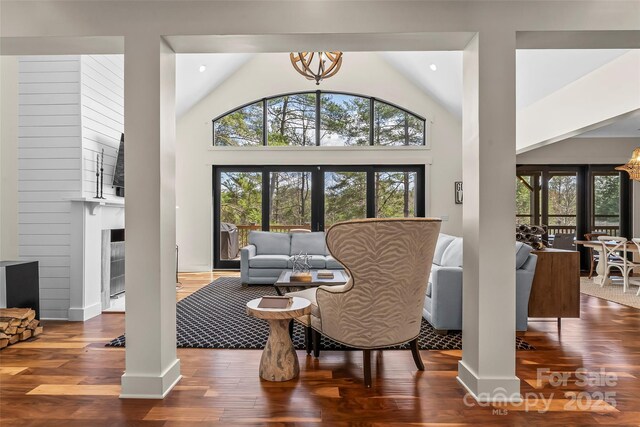 1289 Northview Dr, Morganton, NC 28655 - living area with high vaulted ceiling, wood finished floors, a notable chandelier, and a fireplace
