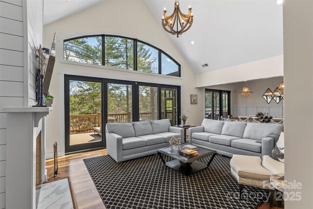1289 Northview Dr, Morganton, NC 28655 - living room with visible vents, high vaulted ceiling, recessed lighting, a chandelier, and light wood finished floors
